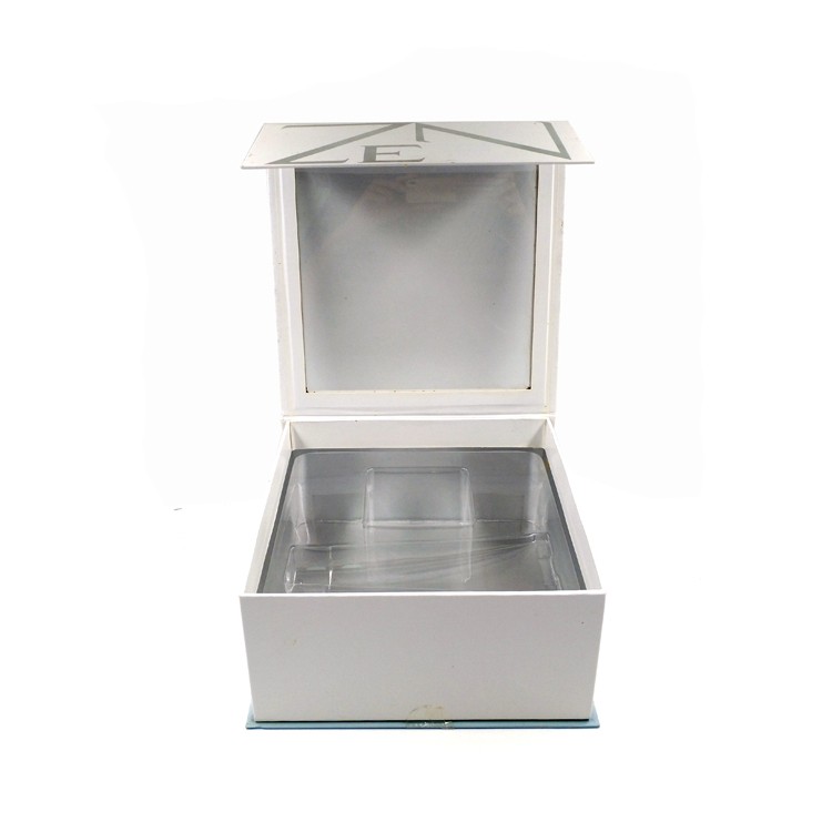 Hinged lid cosmetic box with blister
